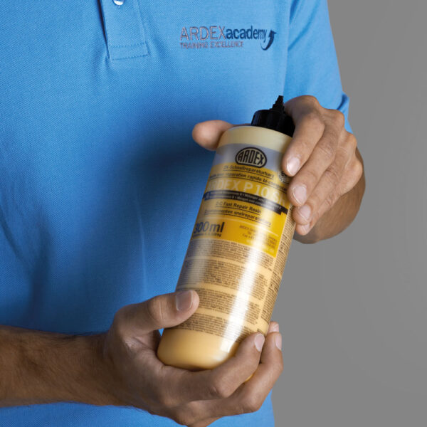 ARDEX P 10 SR Crack Repair Resin - 600ml Kit in someone's hands