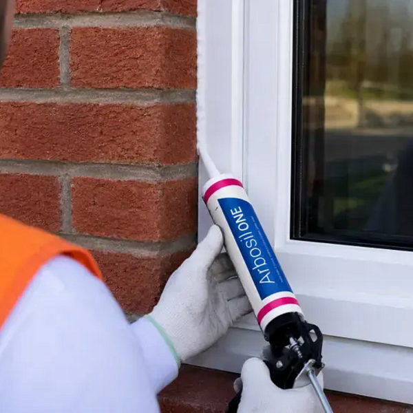 Man using an Arbosil ONE buff cartridge on a window frame.