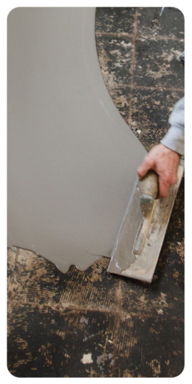 Ardex Levelling Application Man using levelling compound on floor