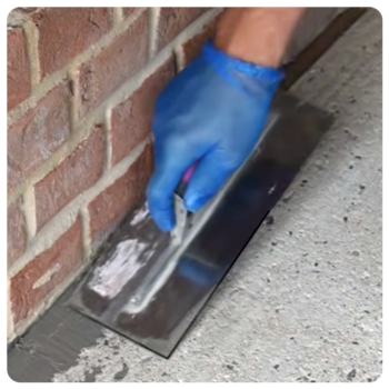 Levelling Compoind A46 Man applying repair mortar to a corner