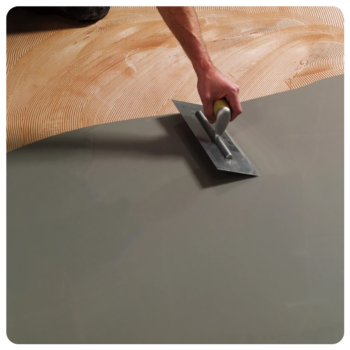 Man Leveling Floor Man Applying Leveling Compound to Floor